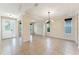 Bright living room featuring neutral colors, tile floors, a modern light fixture, and lots of natural light at 8565 Tallfield Ave # 1, Orlando, FL 32832