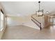 Spacious living room with tile flooring, staircase, and lots of natural light flowing through the windows at 8565 Tallfield Ave # 1, Orlando, FL 32832