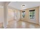 Neutral living room featuring tile floors, a modern light fixture, lots of windows, and a white front door at 8565 Tallfield Ave # 1, Orlando, FL 32832