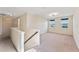 Upstairs loft area with carpet flooring, windows, and access to other rooms in the home at 8565 Tallfield Ave # 1, Orlando, FL 32832