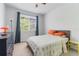 This bedroom is bright and airy and features carpet floors, light blue walls, and lots of natural light at 860 N Orange Ave # 226, Orlando, FL 32801