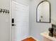 Entryway features modern black hardware on a white door, decorative hooks and mirror at 860 N Orange Ave # 226, Orlando, FL 32801
