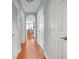 Hallway with wood floors and light blue walls leading to the kitchen at 860 N Orange Ave # 226, Orlando, FL 32801