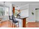 Kitchen island features a black quartz countertop and modern bar stools at 860 N Orange Ave # 226, Orlando, FL 32801