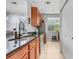This is a kitchen that features wooden cabinets, granite counter tops, stainless steel appliances, and tile floors at 860 N Orange Ave # 226, Orlando, FL 32801