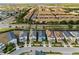 Aerial view of a neighborhood with well-maintained homes, streets, and mature trees at 8953 Amelia Downs Trl, Kissimmee, FL 34747