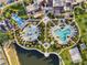 Aerial view of community amenities, including pools, playgrounds, and lush landscaping at 8953 Amelia Downs Trl, Kissimmee, FL 34747