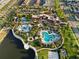 Community aerial view featuring resort-style amenities, including a large pool, playground, and clubhouse at 8953 Amelia Downs Trl, Kissimmee, FL 34747