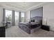 Luxurious bedroom with plush carpeting, elegant chandelier, upholstered headboard, and abundance of natural light at 8953 Amelia Downs Trl, Kissimmee, FL 34747