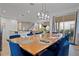 Open dining area with wood table, pendant lighting, seating for ten, and a view to the backyard at 8953 Amelia Downs Trl, Kissimmee, FL 34747