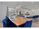 Bright dining area features a wood table, modern lighting, and seating for ten people at 8953 Amelia Downs Trl, Kissimmee, FL 34747