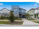 Beautiful two-story home with stone accents, complementing landscaping, and a gray-tone color scheme at 8953 Amelia Downs Trl, Kissimmee, FL 34747