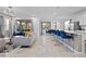 Bright, open-plan living space featuring modern decor, a large sectional sofa, and a stylish kitchen with island seating at 8953 Amelia Downs Trl, Kissimmee, FL 34747