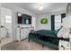 Stylish main bedroom with a mounted TV, mirrored dresser, modern decor, and connected ensuite bathroom at 8953 Amelia Downs Trl, Kissimmee, FL 34747