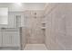 Modern bathroom shower with tiled walls, glass enclosure, and built-in shelving, complementing the vanity area at 8953 Amelia Downs Trl, Kissimmee, FL 34747