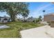 Spacious backyard with mature trees, manicured lawn, and concrete pad perfect for outdoor entertaining at 9000 Us Highway 192 # 624, Clermont, FL 34714