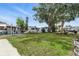 Large, grassy backyard featuring mature trees and meticulously maintained landscaping, offering a serene outdoor space at 9000 Us Highway 192 # 624, Clermont, FL 34714