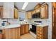 Functional kitchen featuring wood cabinets and standard appliances for meal preparation at 9000 Us Highway 192 # 624, Clermont, FL 34714