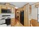 Efficient kitchen featuring wood cabinetry, essential appliances, and seamless flow to other rooms at 9000 Us Highway 192 # 624, Clermont, FL 34714