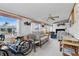 Cozy living room featuring plush seating, a ceiling fan, and plenty of natural light from the large windows at 9000 Us Highway 192 # 624, Clermont, FL 34714
