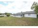 View of the backyard with the home's screened-in porch at 9311 Sonia St, Orlando, FL 32825