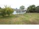 Spacious backyard with a swing set, a tree, and partial view of the home at 9311 Sonia St, Orlando, FL 32825