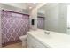 Bathroom with a large mirror, white vanity, patterned shower curtain, and a toilet at 9311 Sonia St, Orlando, FL 32825