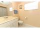 Bathroom featuring a vanity with sink, toilet, framed art, and a shower-tub combo with curtain at 9311 Sonia St, Orlando, FL 32825