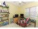 Cozy bedroom featuring a window with natural light, a desk area, and storage at 9311 Sonia St, Orlando, FL 32825