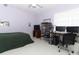 Spacious bedroom with tile flooring, featuring dual computer monitors and a bird cage at 9311 Sonia St, Orlando, FL 32825