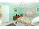 Well-lit bedroom featuring light green walls, a floral bedspread, and a dresser at 9311 Sonia St, Orlando, FL 32825