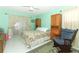 Cozy bedroom with floral bedding, rocking chair, and ample closet space at 9311 Sonia St, Orlando, FL 32825