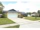 Traditional home featuring an attached two-car garage and front yard landscaping at 9311 Sonia St, Orlando, FL 32825