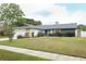 Well-maintained home with manicured lawn, landscaping, and stone accents at 9311 Sonia St, Orlando, FL 32825