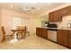 Kitchen and dining area feature matching cabinets, tile flooring, and stainless steel appliances at 9311 Sonia St, Orlando, FL 32825