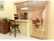 Bright kitchen with a breakfast bar overlooking the dining area, featuring tile floors at 9311 Sonia St, Orlando, FL 32825
