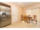 Bright kitchen and dining area with tile floors, stainless steel fridge, and table seating at 9311 Sonia St, Orlando, FL 32825