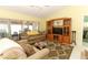 Comfortable living room featuring a built-in entertainment center and access to a screened lanai at 9311 Sonia St, Orlando, FL 32825