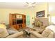 Cozy living room featuring vaulted ceilings, tile fireplace, entertainment center, and comfortable seating at 9311 Sonia St, Orlando, FL 32825