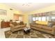 Comfortable living room featuring tile floors and an open layout to the dining area and sunroom at 9311 Sonia St, Orlando, FL 32825