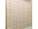 Close-up of the shower with a patterned shower curtain with soft muted colors at 9311 Sonia St, Orlando, FL 32825
