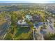 Drone shot of community pool with splash pad, lounge, clubhouse, parking, and adjacent neighborhood with trees at 970 Timberview Rd, Clermont, FL 34715