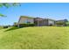 Spacious backyard featuring a well-maintained lawn and privacy hedge, perfect for outdoor activities and relaxation at 970 Timberview Rd, Clermont, FL 34715