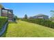 Manicured backyard with lush green lawn, privacy hedge, and well-maintained landscaping at 970 Timberview Rd, Clermont, FL 34715