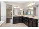 Bright bathroom with double vanities, large mirror, and tile flooring at 970 Timberview Rd, Clermont, FL 34715
