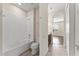 Hall bathroom with shower-tub combo and tile flooring at 970 Timberview Rd, Clermont, FL 34715