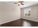 Bedroom featuring wood floors, neutral paint, white trim and window with bright light at 970 Timberview Rd, Clermont, FL 34715