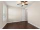 This bedroom offers wood floors, neutral paint, white trim and a ceiling fan at 970 Timberview Rd, Clermont, FL 34715