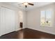 Bedroom with wood floors, window with shutters and ensuite bathroom at 970 Timberview Rd, Clermont, FL 34715