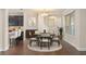 Dining room with hardwood floors and natural lighting, adjacent to the bar and kitchen at 970 Timberview Rd, Clermont, FL 34715